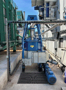 A blue machine outside of a building<br />
<br />
AI-generated content may be incorrect.